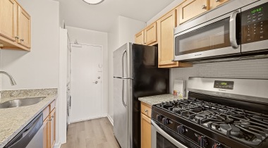 Well-Lit Kitchen with Wood-Style Flooring at Our Apartments for Rent in Arlington, Virginia