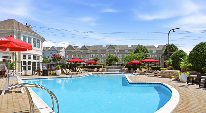 Resort-Style Pool and Sun Deck with Lounge Chairs Nearby at Our Dulles Town Center Apartments