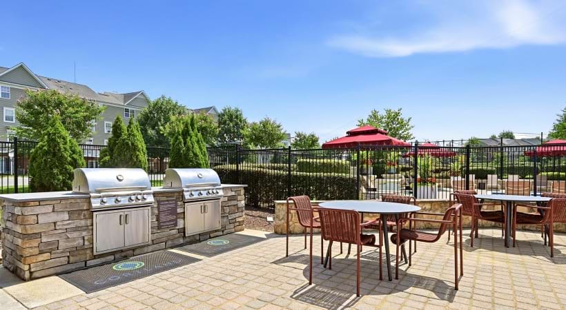 Gas Grills with Tables and Chairs Nearby at Our Apartments in Herndon, VA