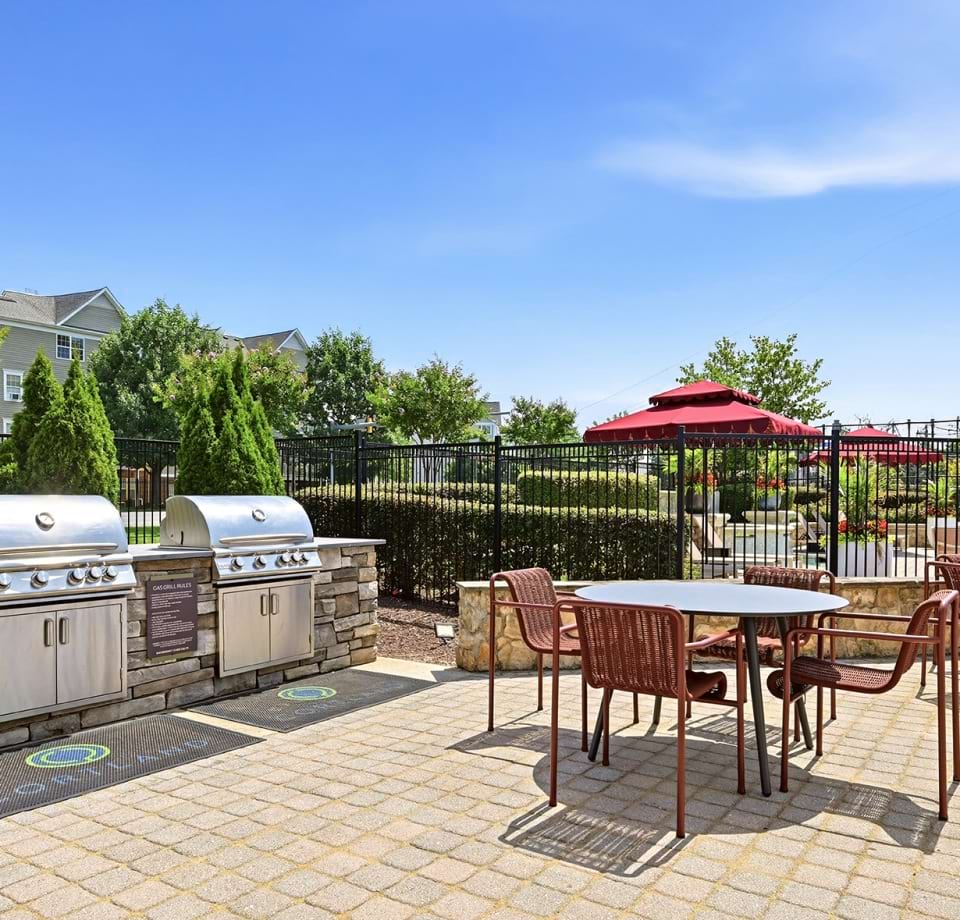 Gas Grills Near Tables and Chairs at Our Apartments Near Dulles Town Center