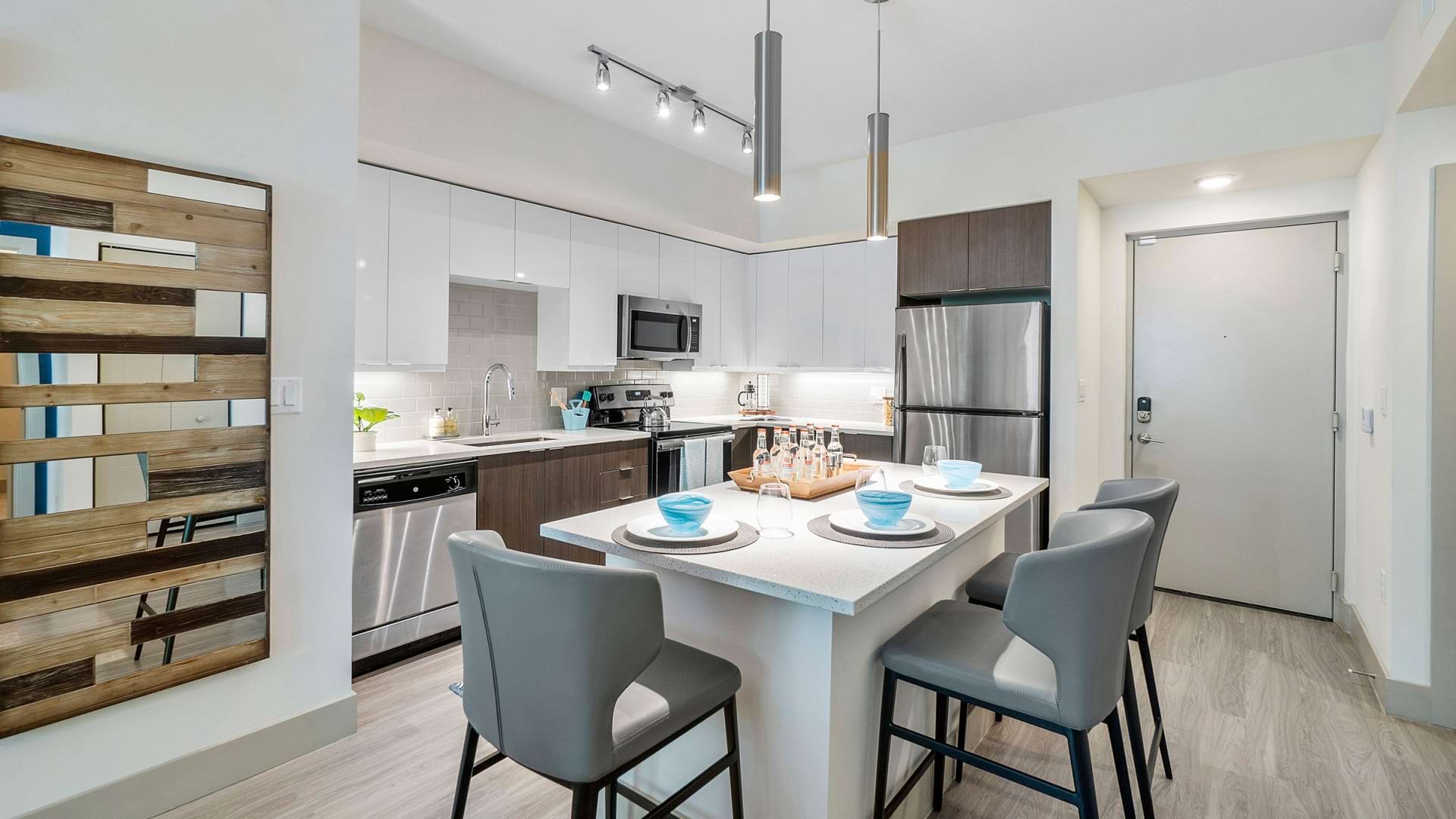 Open-Concept Kitchen with Wood-Style Flooring at Our Apartments in Deerfield Beach