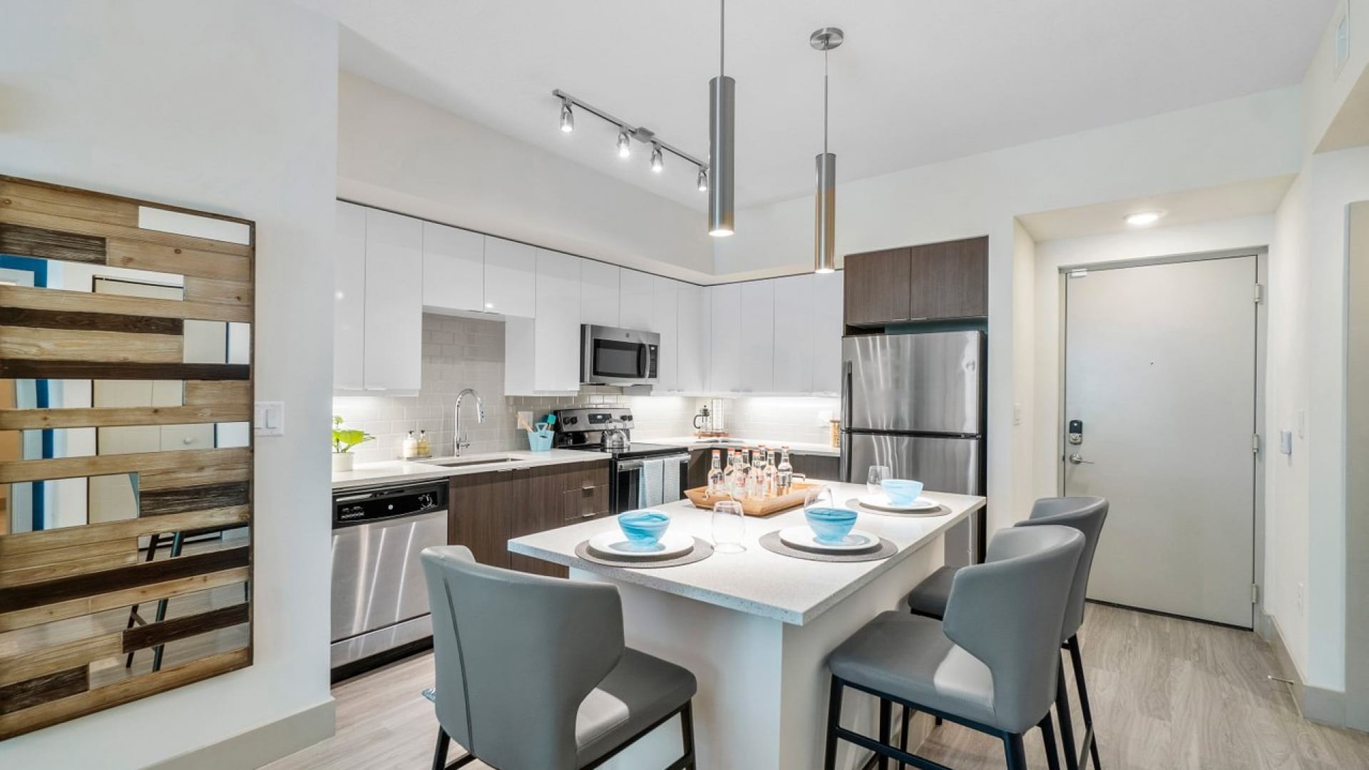Kitchen with Two-Tone Cabinets and Modern Lighting at Our Luxury Apartments in Deerfield Beach, FL