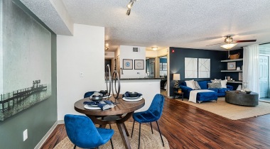 Open-Concept Dining and Living Area with Wood-Style Flooring at Our Lake Howell Apartments