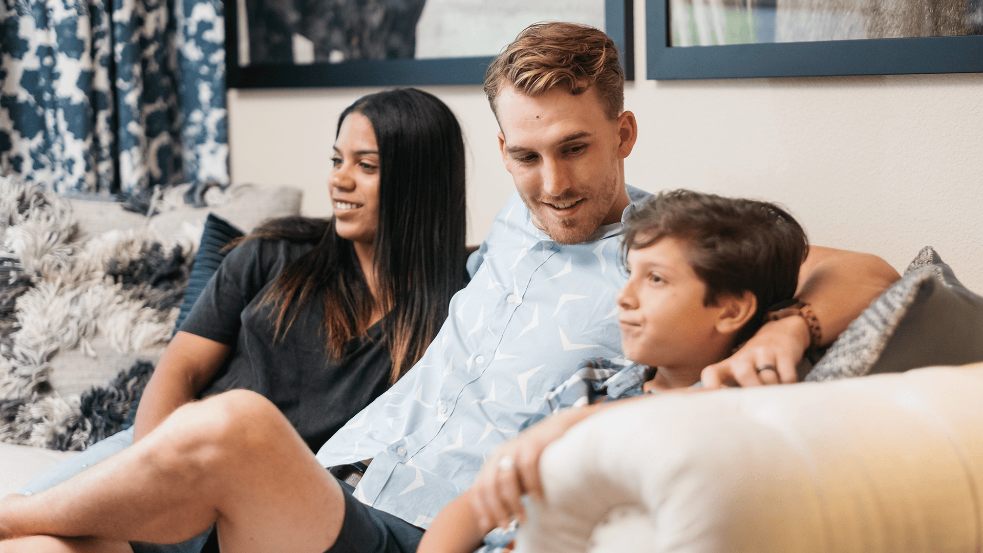 Family Sitting on Couch at Our Cortland Apartments