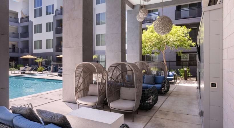 Poolside Lounge with a Fireplace and Fire Pits at Our Apartments in Biltmore, AZ