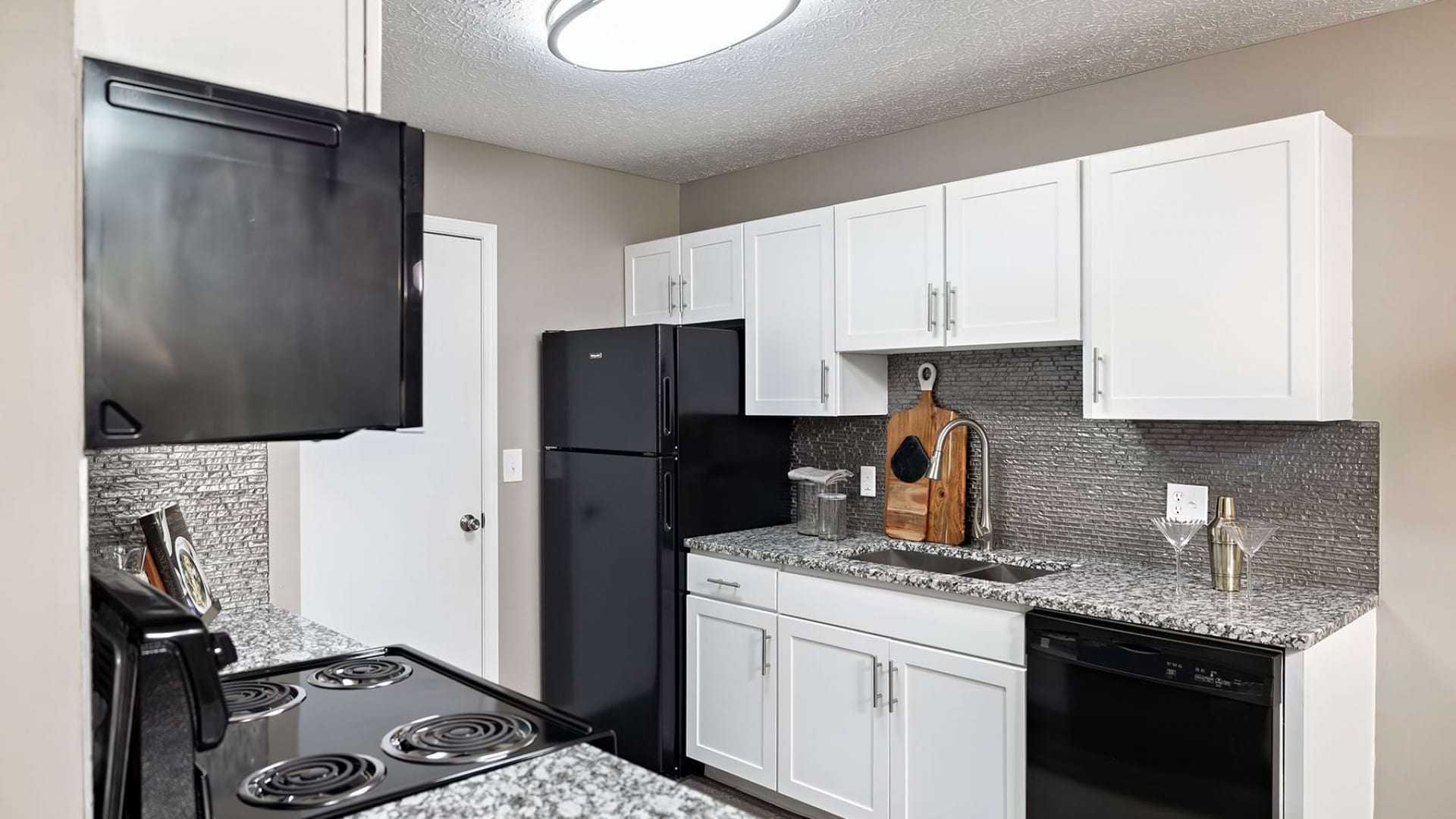 Kitchen Area with Granite Countertops at Our East Broad Apartments