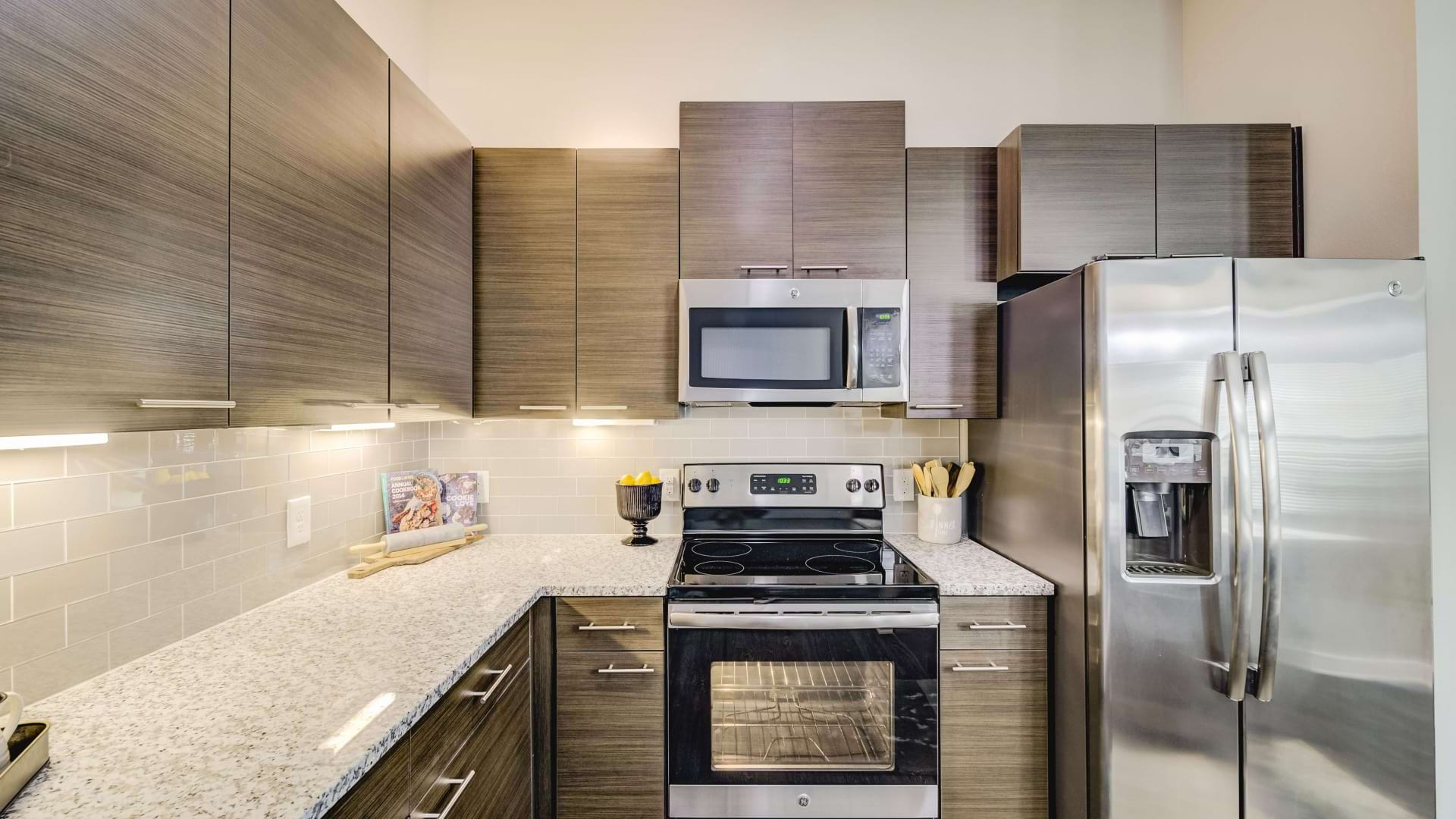 Modern apartment kitchen with stainless steel appliances at Las Colinas luxury apartments