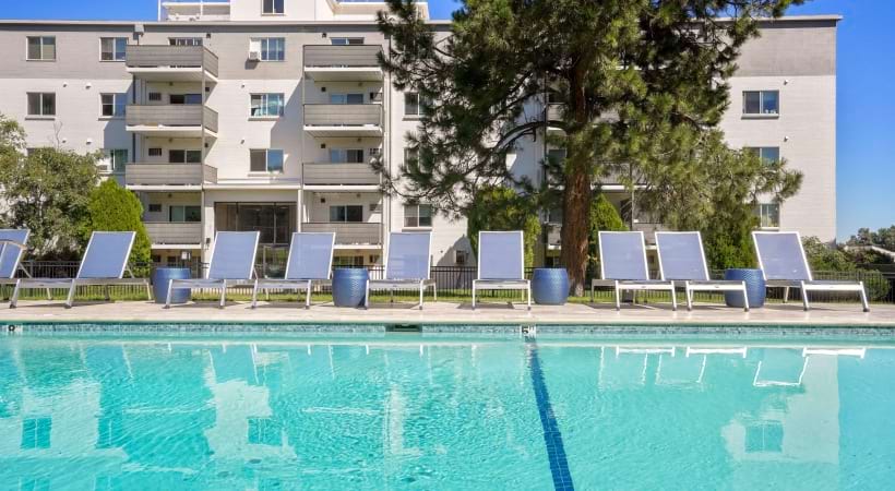 Sparkling Swimming Pool with Lounge Chairs at Our Apartments on Colorado Blvd in Denver