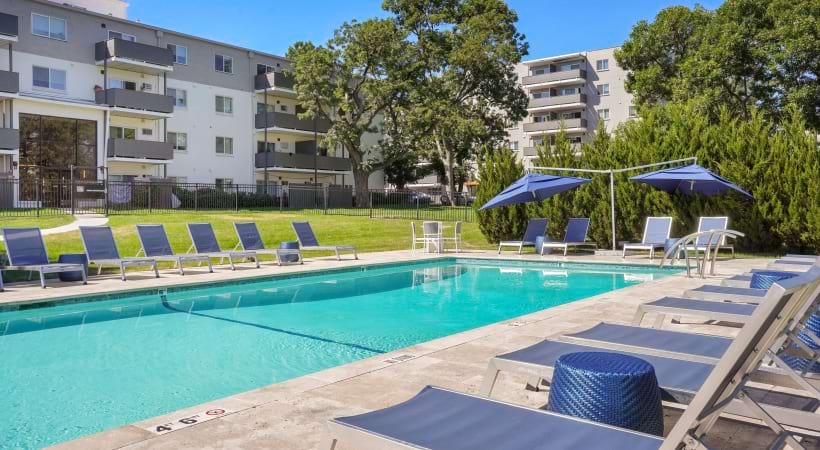 Sparkling Swimming Pool with Lounge Chairs at Our Apartments on Colorado Blvd in Denver