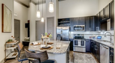 Model kitchen of our modern apartments near Legacy West with modern furniture and wall decor