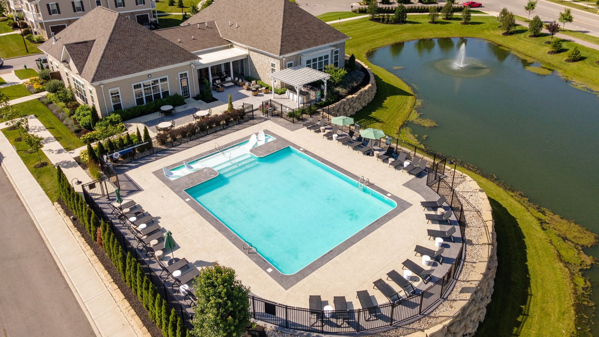 Aerial View Of The Pool And Community Lake At Our Sunbury Apartment Homes