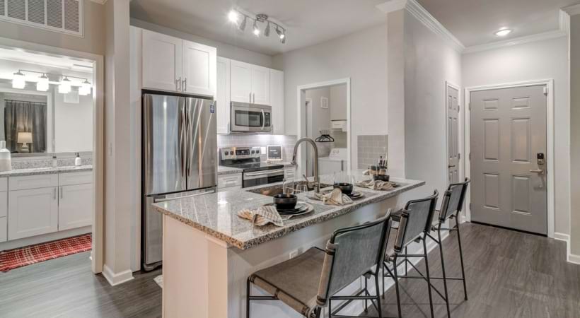Our Apartments in Euless, TX with a Kitchen Island and Modern Lighting