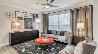 Spacious living room with modern decor and wood-style flooring at our Bear Creek apts 