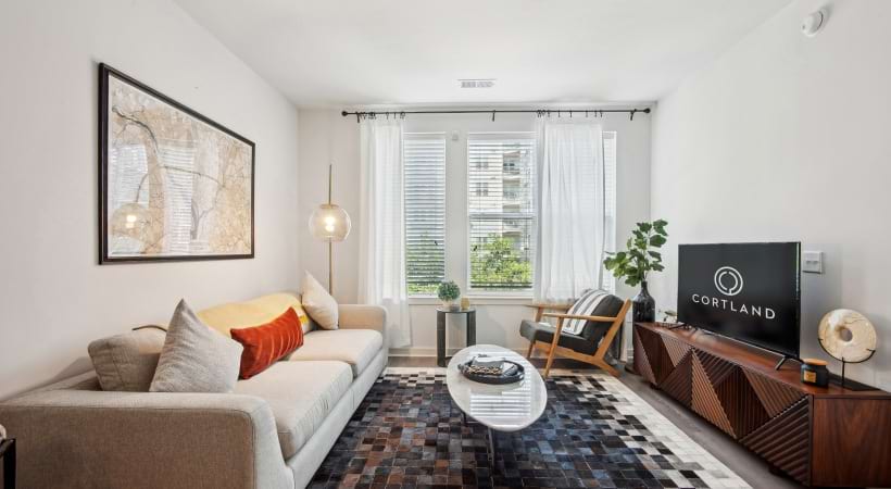 Large Living Room with Natural Lighting and Wood-Style Flooring at Our Columbia Pike, VA Apartment Homes