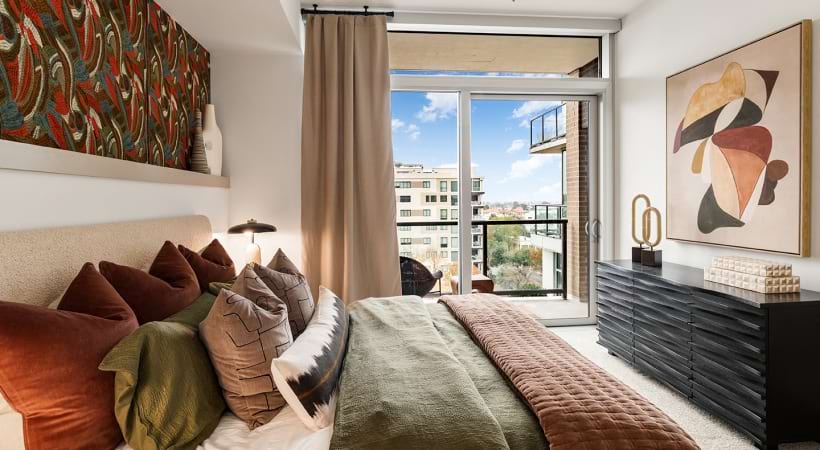 Bedroom with a Floor-to-Ceiling Window and Balcony Access in Our Apartments Near TSU