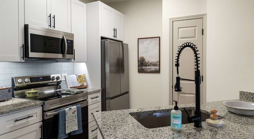 Kitchen with a Breakfast Bar in Our Apartments in Jersey Village Near Houston