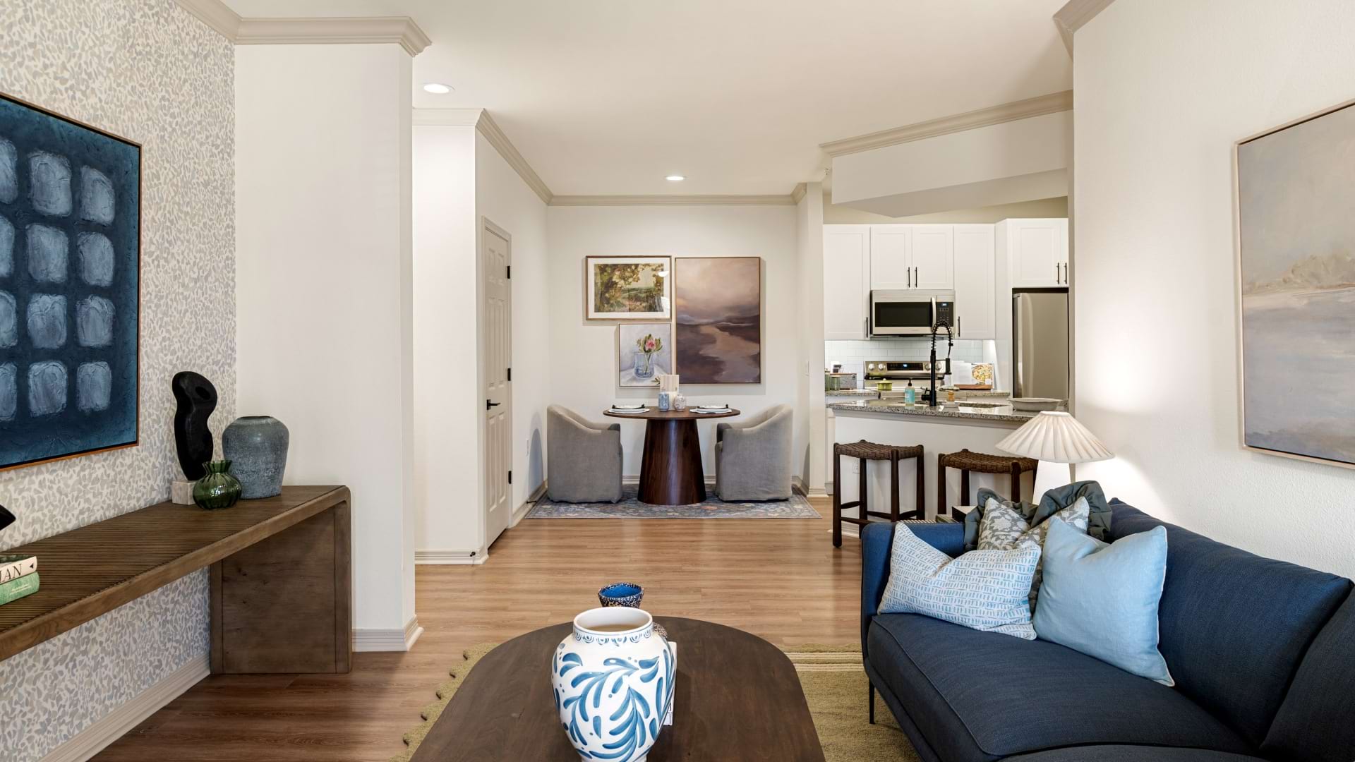 Living and Dining Areas with Wood-Style Flooring in Our Apartments Near Jersey Village in Houston
