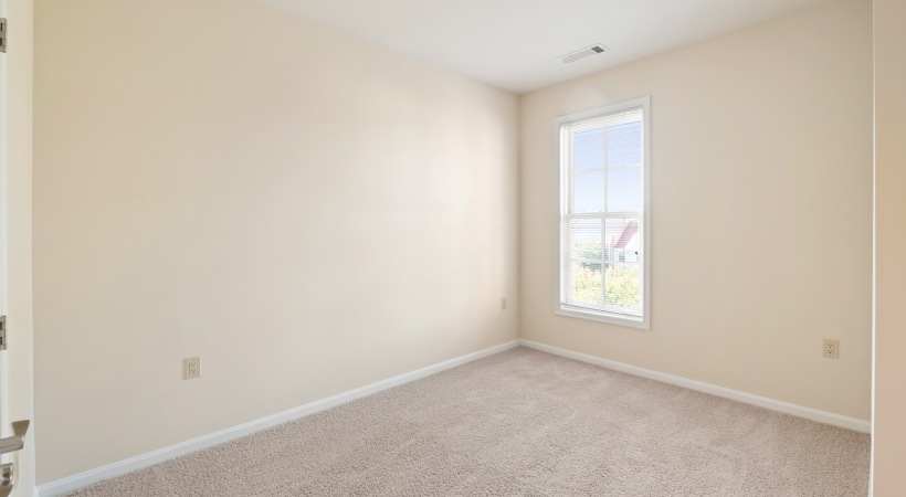 unfurnished bedroom with large windows
