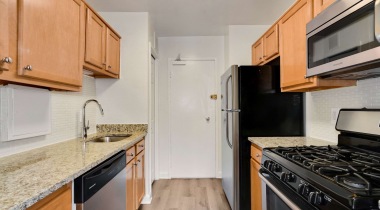 Well-Lit Kitchen with Wood-Style Flooring at Our Apartments for Rent in Arlington, Virginia