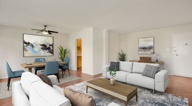 Living Room with Wood-Style Flooring and a Ceiling Fan at Our Apartments Near Columbia Pike