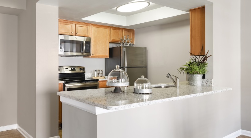 Well-Lit Kitchen with Energy-Efficient, Stainless Steel Appliances at Our Apartments in Arlington