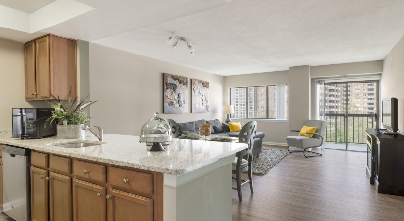 Open Floor Plan Kitchen and Living Room with Wood-Style Flooring at Our Apartments for Rent in Arlington