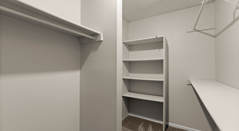 Spacious Walk-In Closet with Built-in Shelves at Our Apartments in Marietta, GA